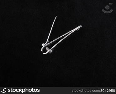 tweezers for nails on a black background