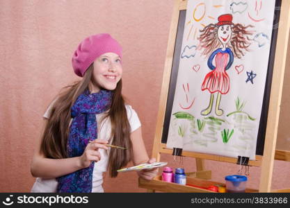 Twelve year old girl draws a picture on the easel