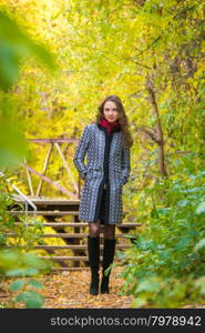 Twenty-five young beautiful girl walks by Europeans autumn forest. Girl walks in the warm autumn weather