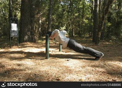 Twenty-six year old man working out at park.