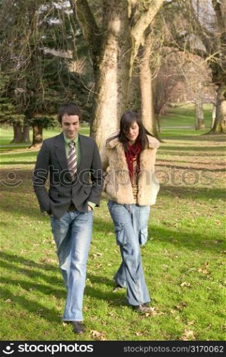 Twenty Something Couple Walking Through The Park
