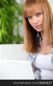 Twentysomething woman sitting at a laptop