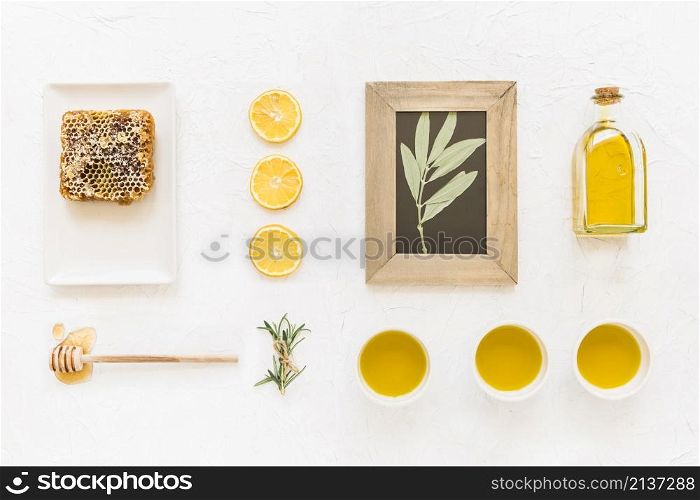 twig wooden frame with oil ingredients honeycomb