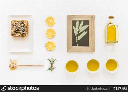 twig wooden frame with oil ingredients honeycomb
