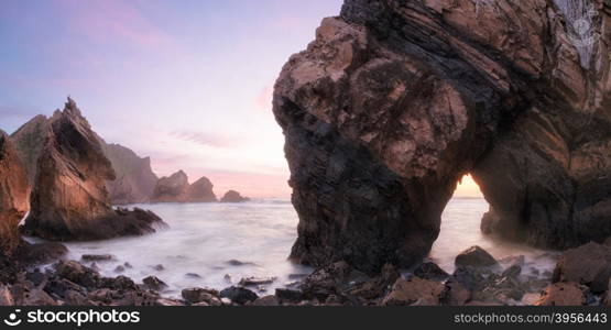 Twilight at rocky coastline of Atlantic ocean, Ursa beach, Portugal