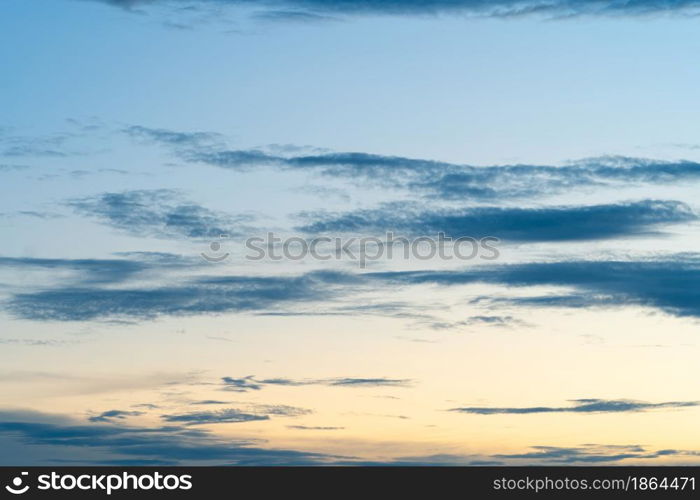 Twilight blue bright and orange yellow dramatic sunset sky in countryside or beach colorful cloudscape texture with white clouds air background.