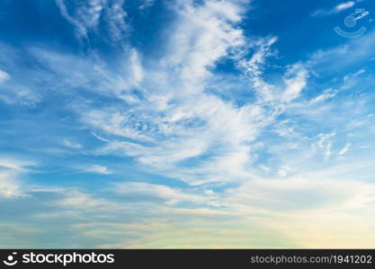 Twilight blue bright and orange yellow dramatic sunset sky in countryside or beach colorful cloudscape texture with white clouds air background.