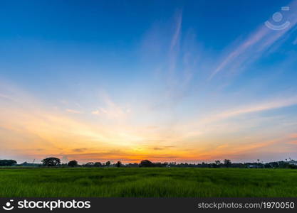 Twilight blue bright and orange yellow dramatic sunset sky in countryside or beach colorful cloudscape texture with white clouds air background.