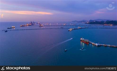 twilight seascape and shipping port loading oil and gas on the sea in Thailand aerial view