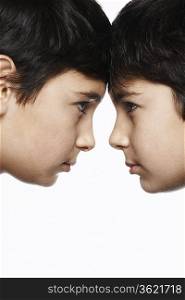 Twin boys (13-15) head to head, close-up