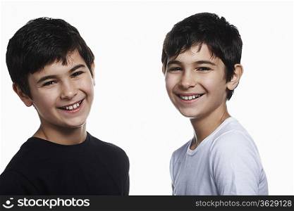 Twin boys (13-15) smiling, portrait
