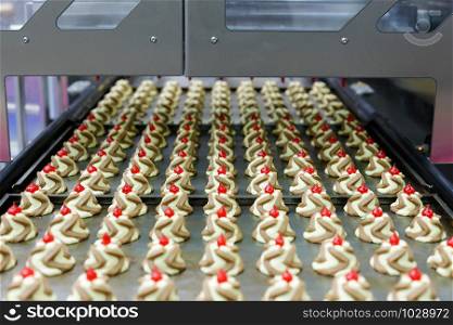Twin colour jam drops cookies on a production line. Selective focus.