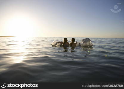 Twin sisters paddle out to sea on air bed