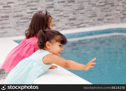 Twin sisters two years playing near the pool