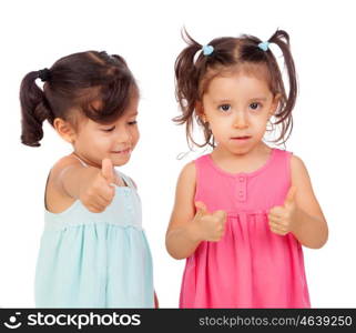 Twin sisters two years saying Ok isolated on a white background