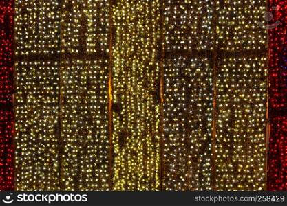 Twinkling christmas lights background. Wall illuminated by Christmas lights