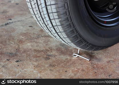 twist nail under car wheel