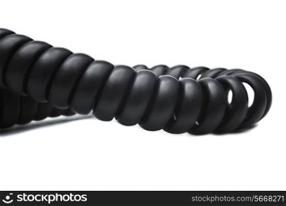 Twisted black telephone cord on white background close-up