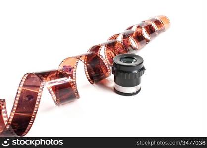 twisted negative film and magnifier isolated on white background