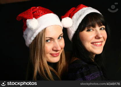 two 20-25 years women friends having fun on a christmas party