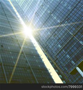 Two abstract skyscrapers with sun glare