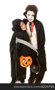 Two adorable boys dressed in their halloween costumes. Full body isolated on white.