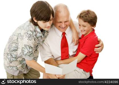 Two adorable boys giving their father a greeting card. Perfect for Fathers Day or other special occasion.