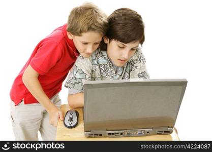 Two adorable brothers using the computer together. Isolated on white.