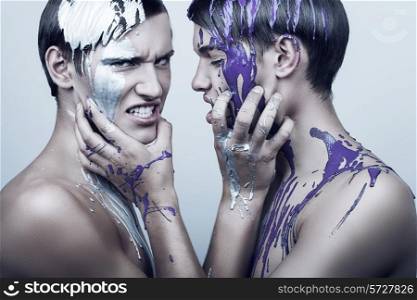 two adult men in silver and violet paint