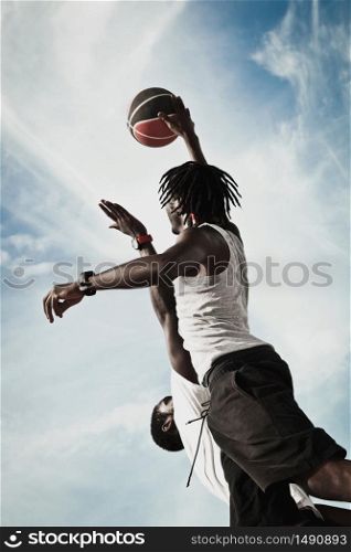 Two African American Playing basketball