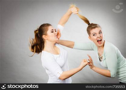 Two agressive women having argue fight being mad at each other. Female violance concept.. Two agressive women having argue fight