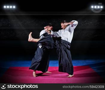 Two aikido fighters at sports hall