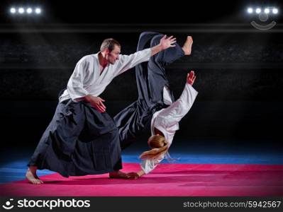 Two aikido fighters at sports hall