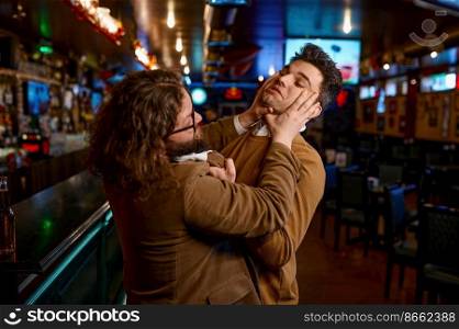 Two angry friends quarreling and fighting at sport bar. Furious soccer fans grimacing and pushing each other. Two angry friends quarreling with each other fighting at sport bar