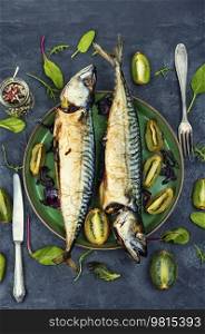 Two appetizing mackerel fish baked with kiwi pieces. Japanese cuisine. Cooking scomber fish with kiwi