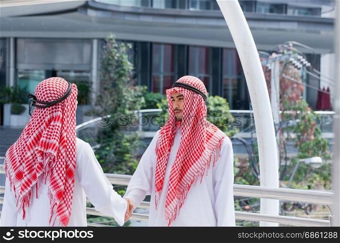 two arabian businessman shake hand and make decision together in modern city