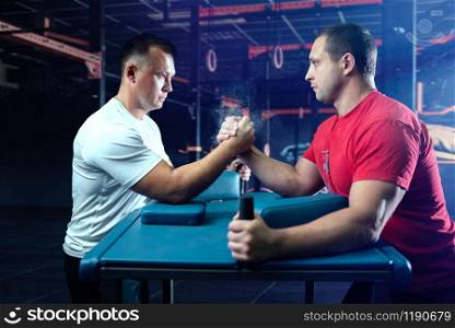 Two arm wrestlers on starting position, wrestling competition. Wrestle challenge, power sport