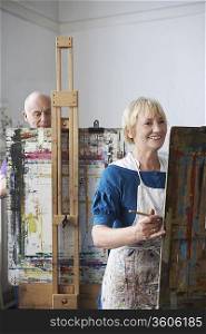 Two artists painting in studio