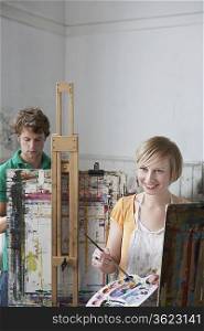Two artists painting in studio