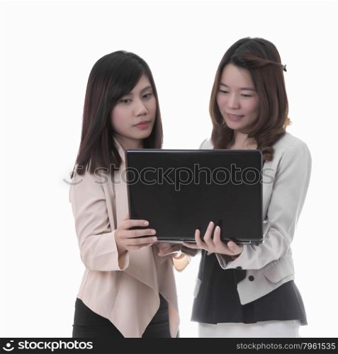 Two asian business woman in office, discussing notebook