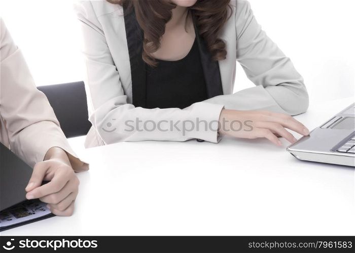 Two asian business woman in office, discussing profile with notebook