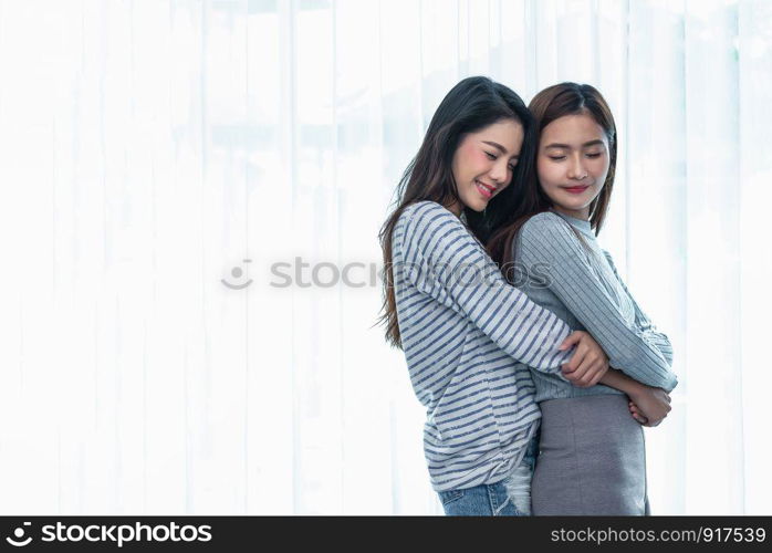 Two Asian Lesbian women hug and embracing together in bedroom. Couple people and Beauty concept. Happy lifestyles and home sweet home theme. Homosexual life theme. Love scene making of female