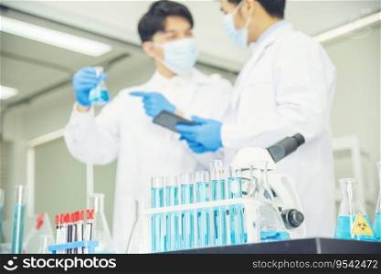 Two asian scientist team reserch chemistry science tube experiment biotech antibody s&le in laboratory Cultivate Vaccine against covid-19 virus. Scientist consult, analyze in Chemistry Laboratory
