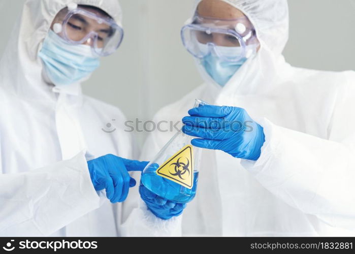 Two asian scientist team reserch chemistry science tube experiment biotech antibody sample in laboratory Cultivate Vaccine against covid-19 virus. Scientist consult, analyze in Chemistry Laboratory