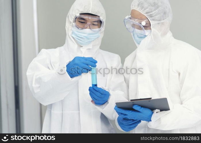 Two asian scientist team reserch chemistry science tube experiment biotech antibody sample in laboratory Cultivate Vaccine against covid-19 virus. Scientist consult, analyze in Chemistry Laboratory