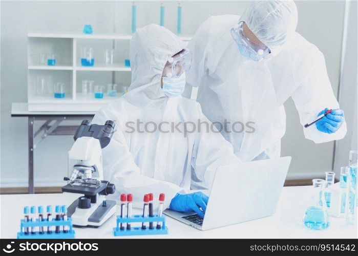 Two asian scientist team reserch chemistry science tube experiment biotech antibody sample in laboratory Cultivate Vaccine against covid-19 virus. Scientist consult, analyze in Chemistry Laboratory