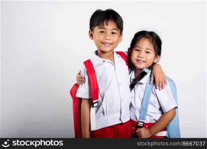 Two Asian student kid girl boy schoolchildren brother sister smile happy wear student thai uniform red pants skirt hug each other isolated on white background, Portrait little children girl preschool