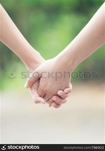 two asian woman holding hands and moving foward