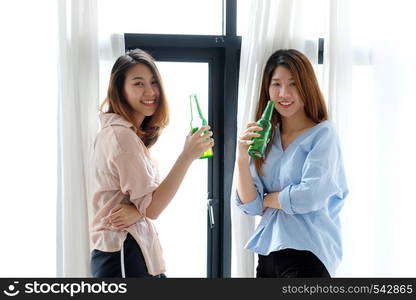 Two asian women drinking beer at party, celebration, LGBT couple, lifestyle