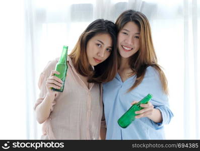 Two asian women drinking beer at party, celebration, LGBT couple, lifestyle